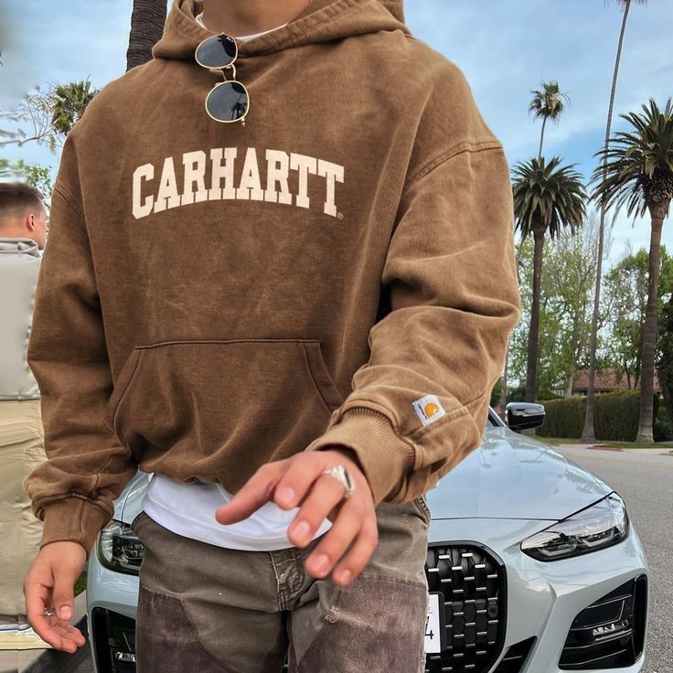 Carhartt washed brown hoodie — hooded, kangaroo pocket, ribbed cuffs and hem, distressed wash, large 'CARHARTT' chest logo, small Carhartt patch on sleeve