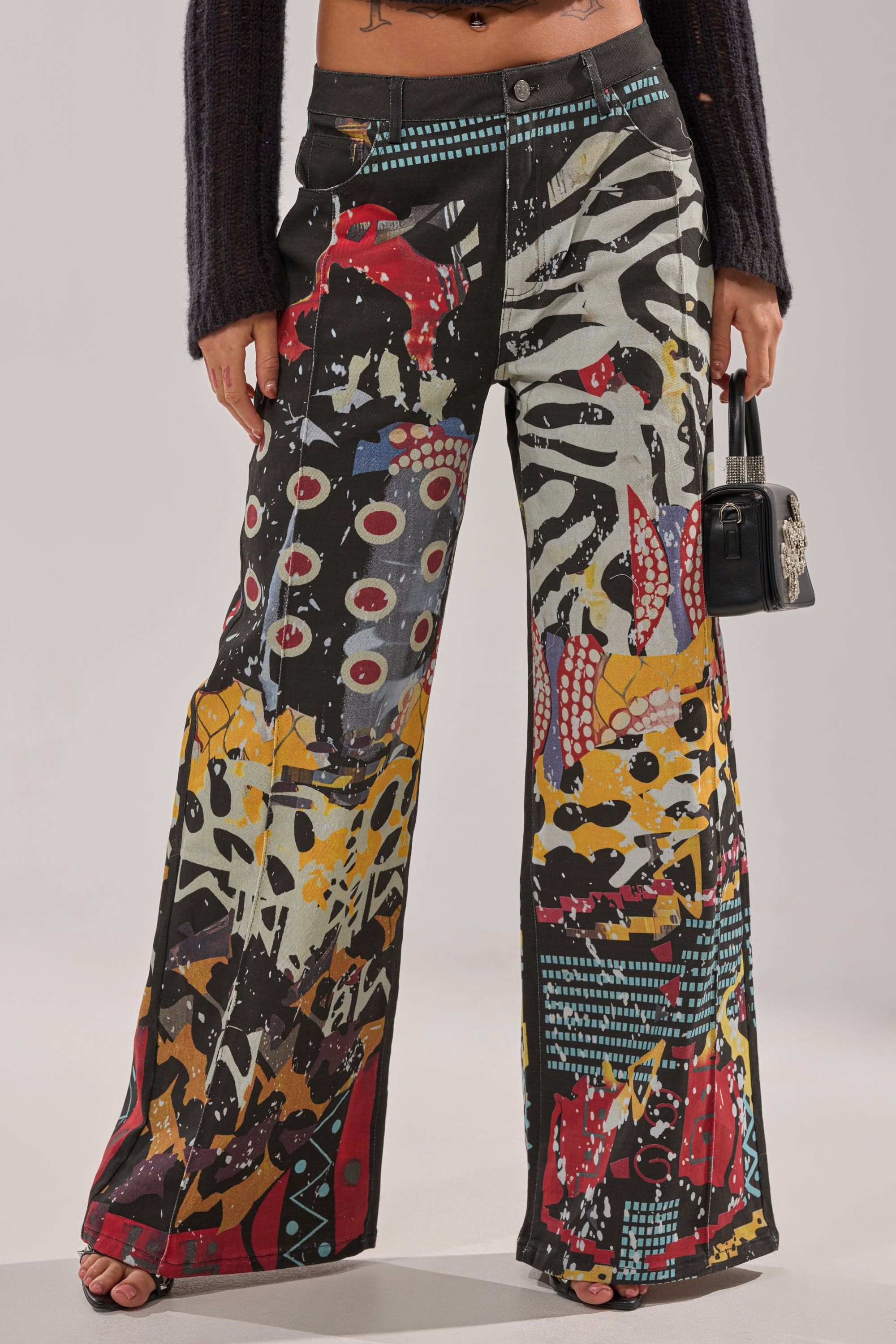 streetwear multi-color wide leg jeans — all-over abstract graphic print, black wash denim base, contrasting vibrant colors