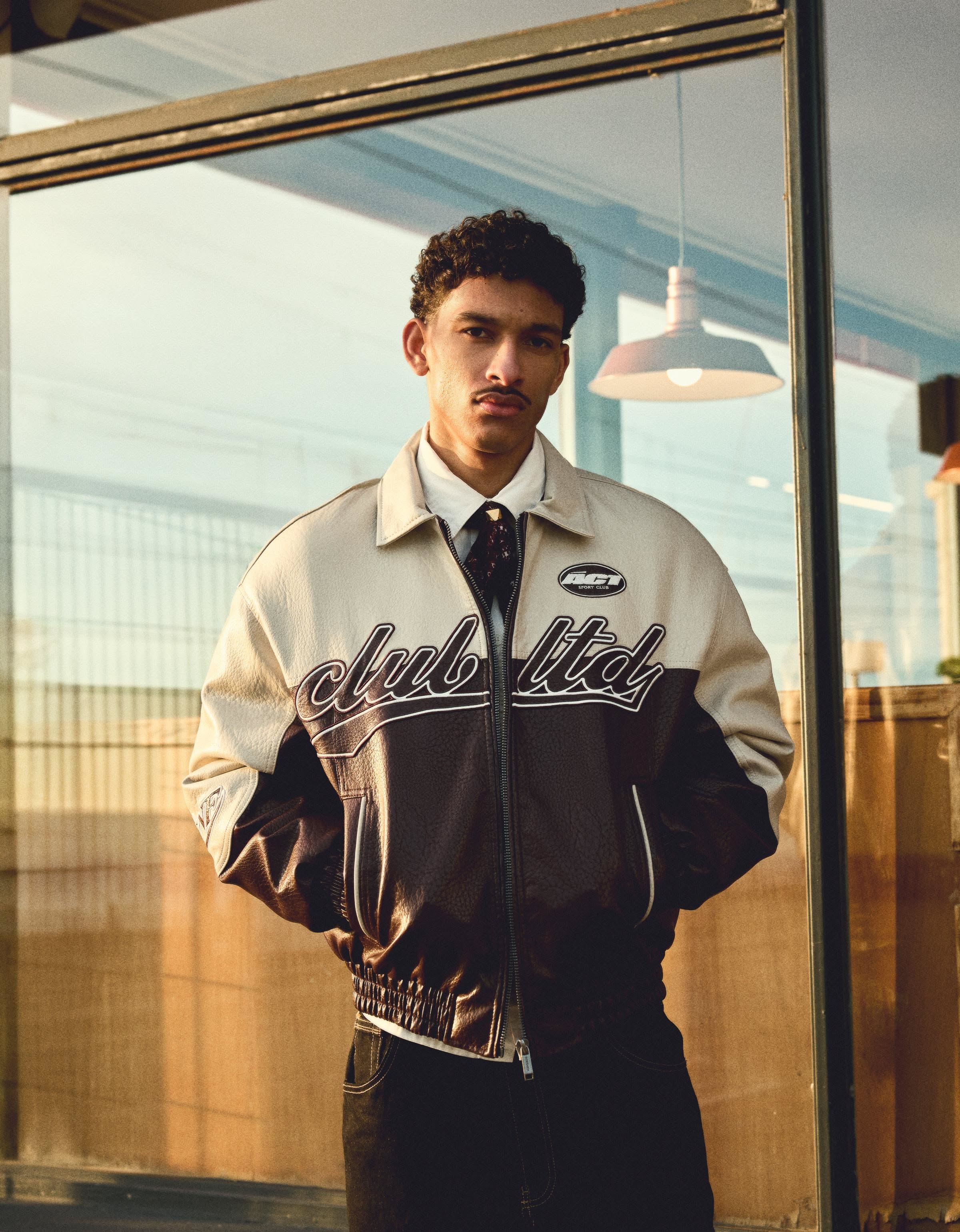 streetwear cream and dark brown bomber jacket — embroidered 'club ltd' text, 'sport club' patch, white piping details, ribbed cuffs and hem, point collar, full zip closure