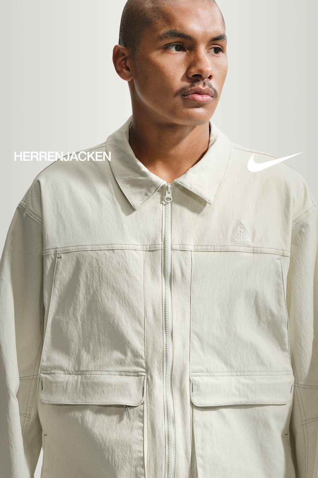 Nike ACG light off-white utility jacket — full zip closure, point collar, chest panel stitching, two flap patch pockets, embroidered triangular logo