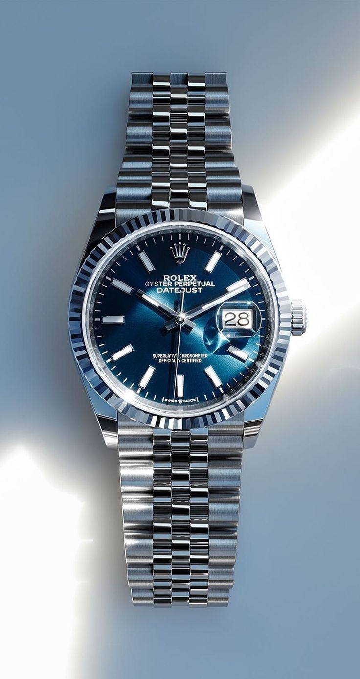 Rolex blue dial, silver-tone case and bracelet watch — fluted bezel, jubilee bracelet, date window with cyclops lens, baton hour markers, sunray dial finish
