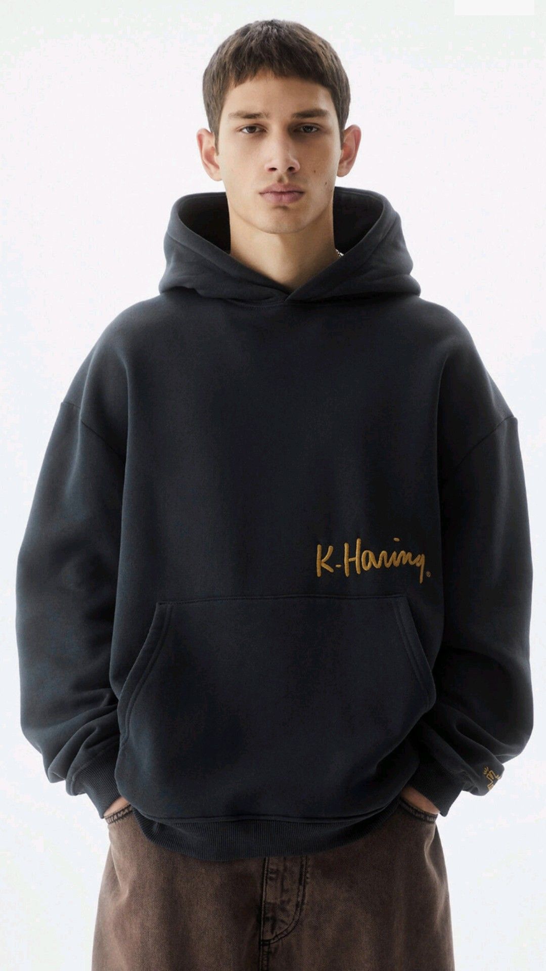 streetwear dark navy hoodie — drawstring hood, front kangaroo pocket, ribbed cuffs and hem, gold embroidered 'K-Haring' text on chest, small gold graphic on sleeve