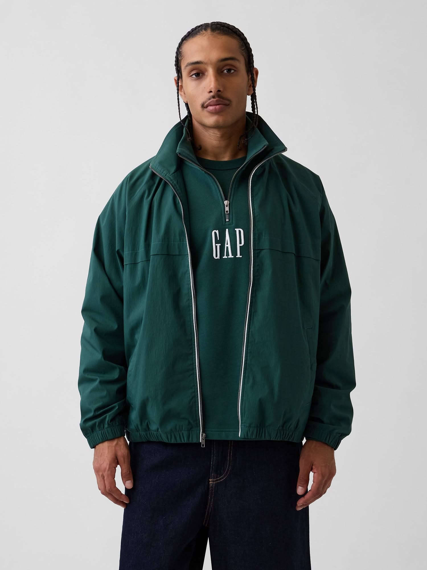 Gap deep forest green track jacket — high collar, full zip closure, white zipper tape, ribbed cuffs and hem, dropped shoulders