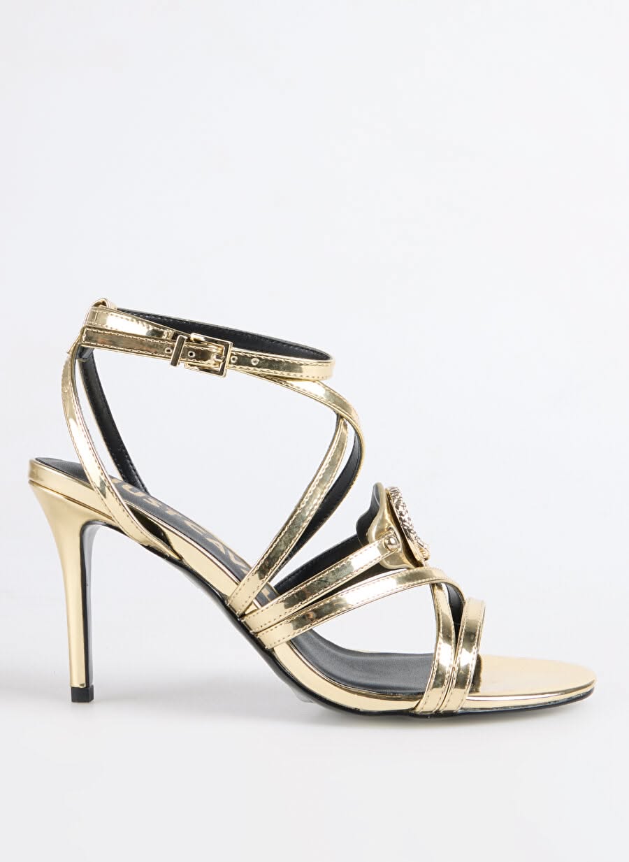 Just Cavalli metallic gold heels — stiletto heel, ankle strap with buckle closure, multiple criss-cross straps, round medallion embellishment with rhinestones, open toe