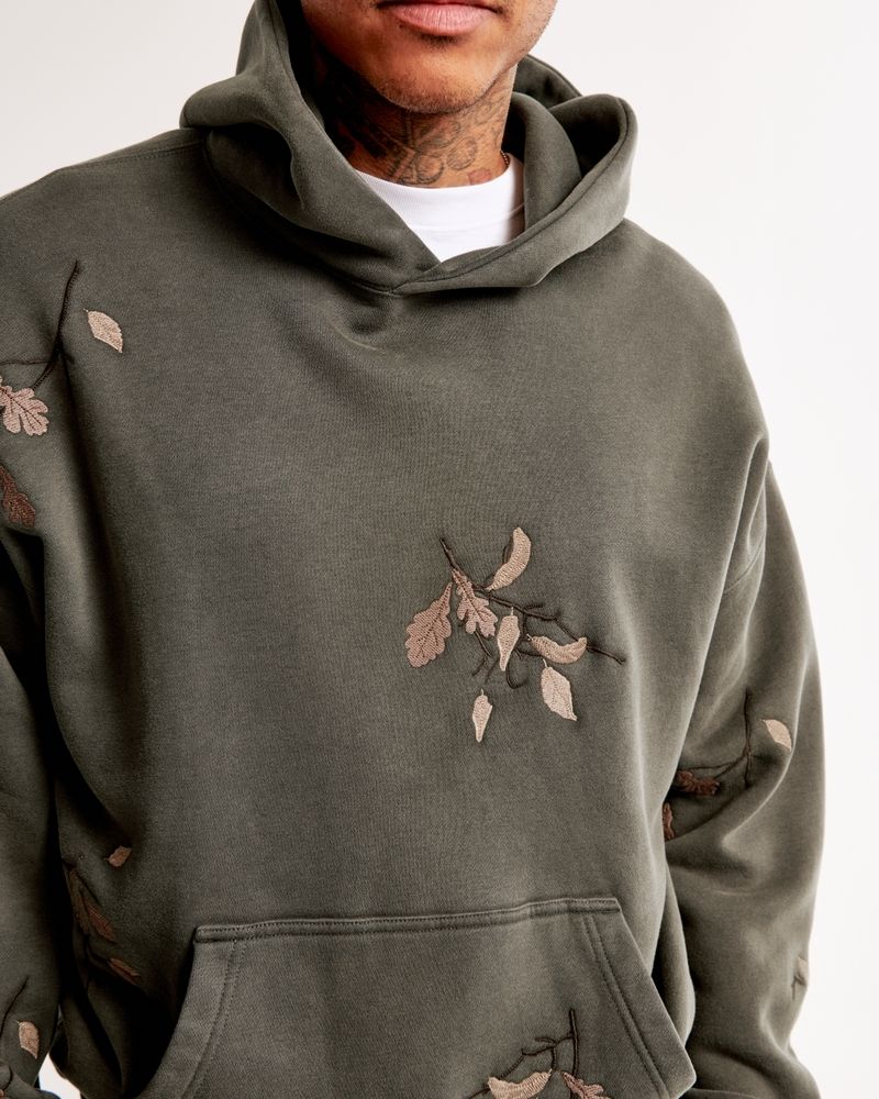 casual dark olive green hoodie — hooded, kangaroo pocket, embroidered leaf and branch motifs, dropped shoulders