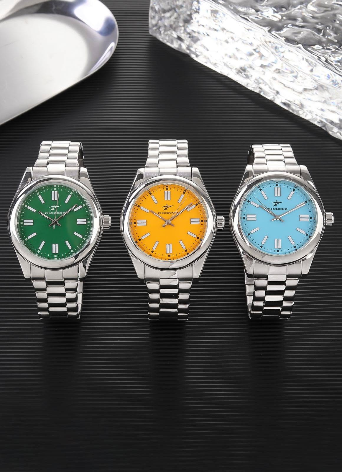 Ricecgo silver with green, orange, or light blue dial wristwatch — round dial, bar hour markers, minute track, three hands, fluted bezel, link bracelet, crown on right