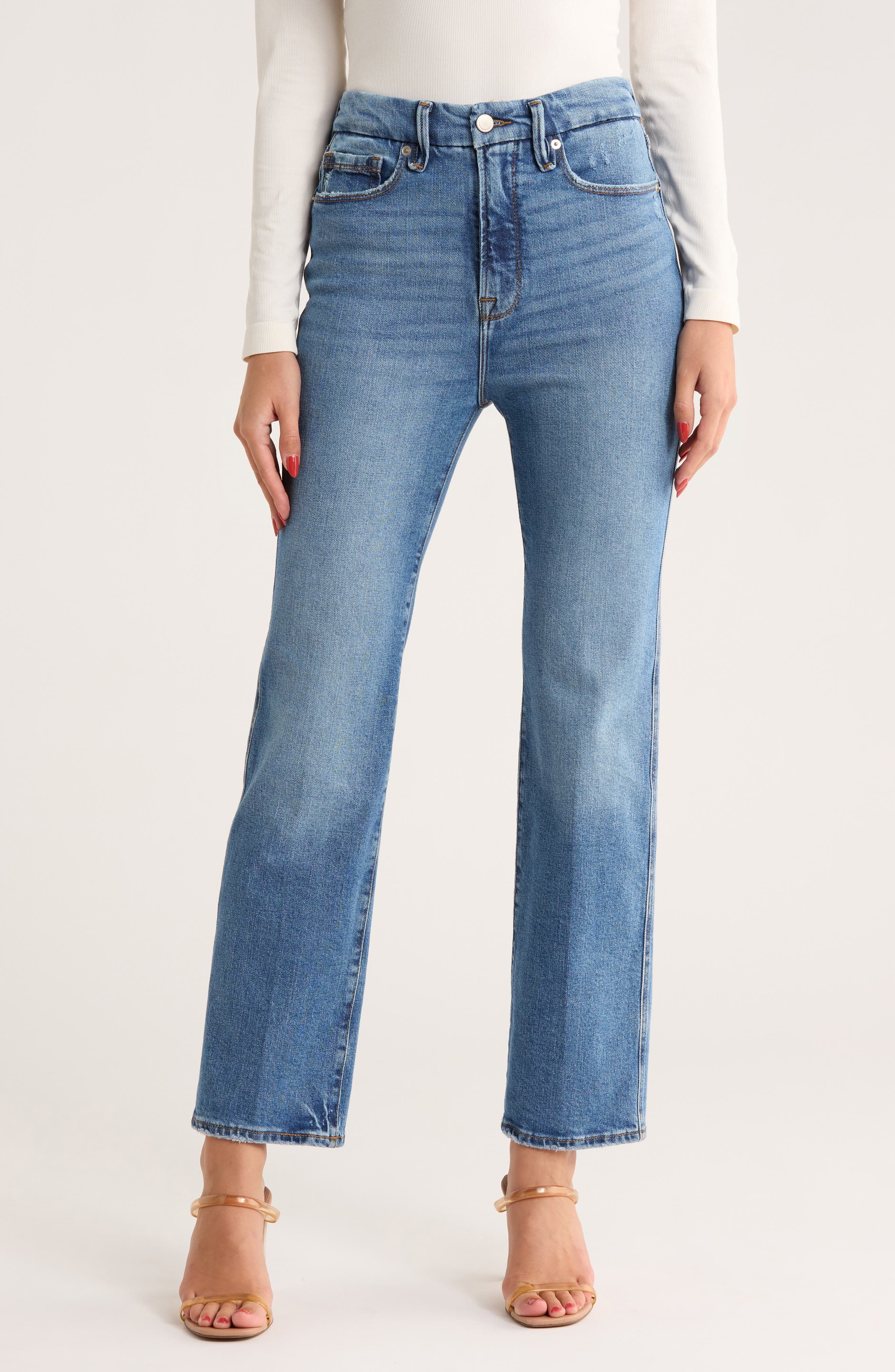 casual medium wash blue jeans — distressed pockets, subtle whiskering, raw hem, cropped length