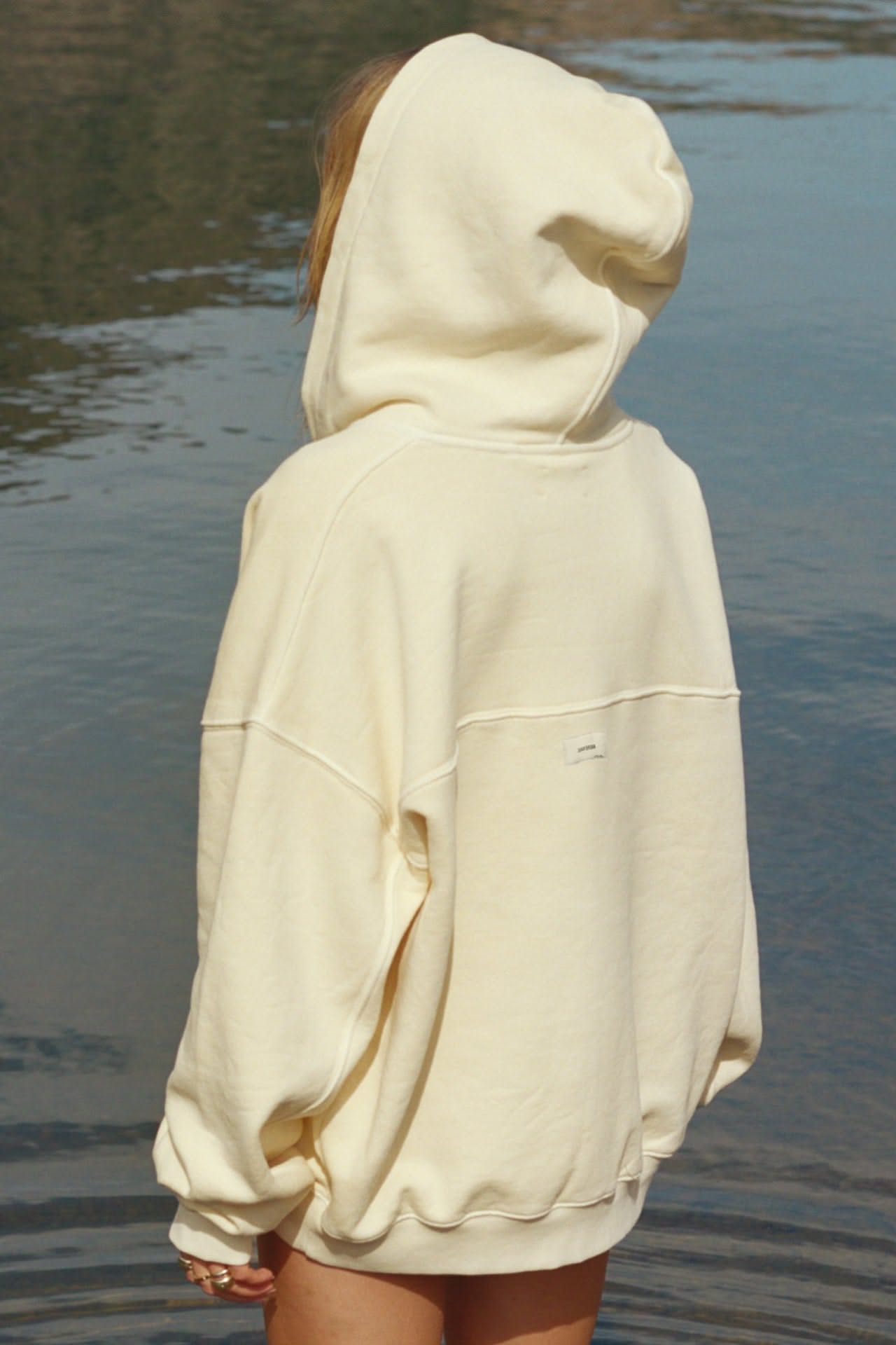 Joah Brown buttercream yellow hoodie — drop shoulder, exposed seam detailing, ribbed cuffs and hem, small brand tag on back