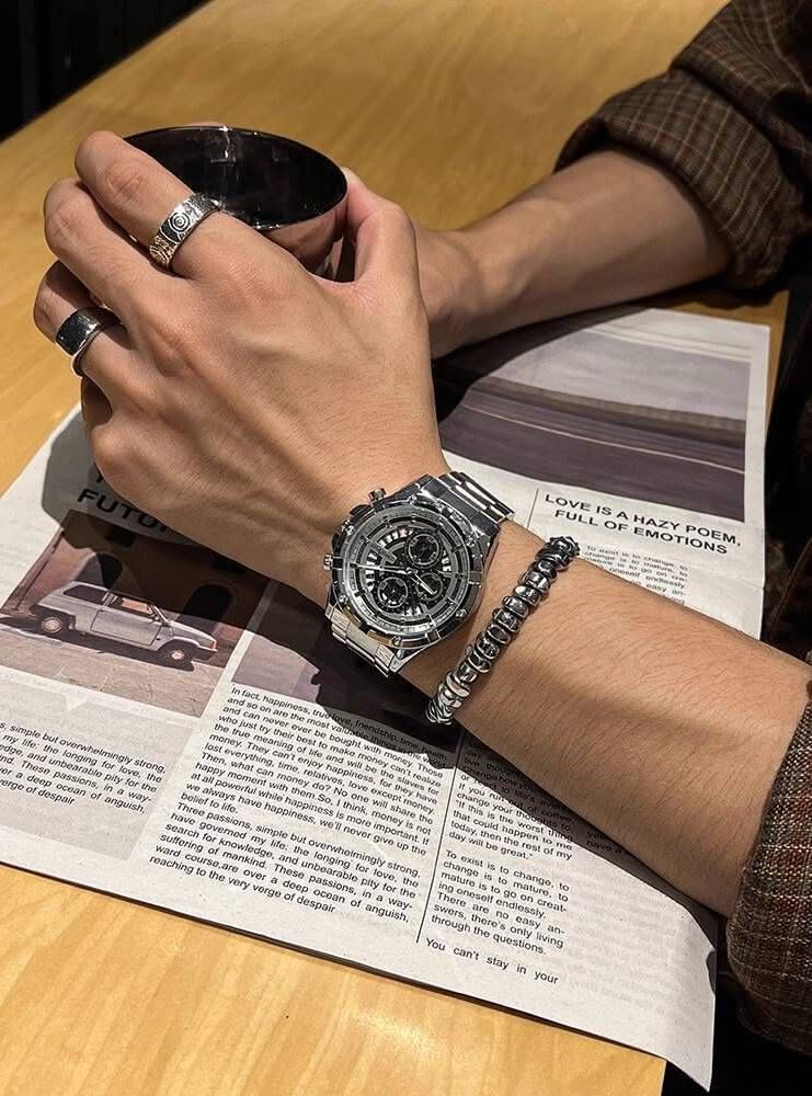 casual silver-tone watch — chronograph, multiple subdials, fluted bezel, link bracelet, pushers