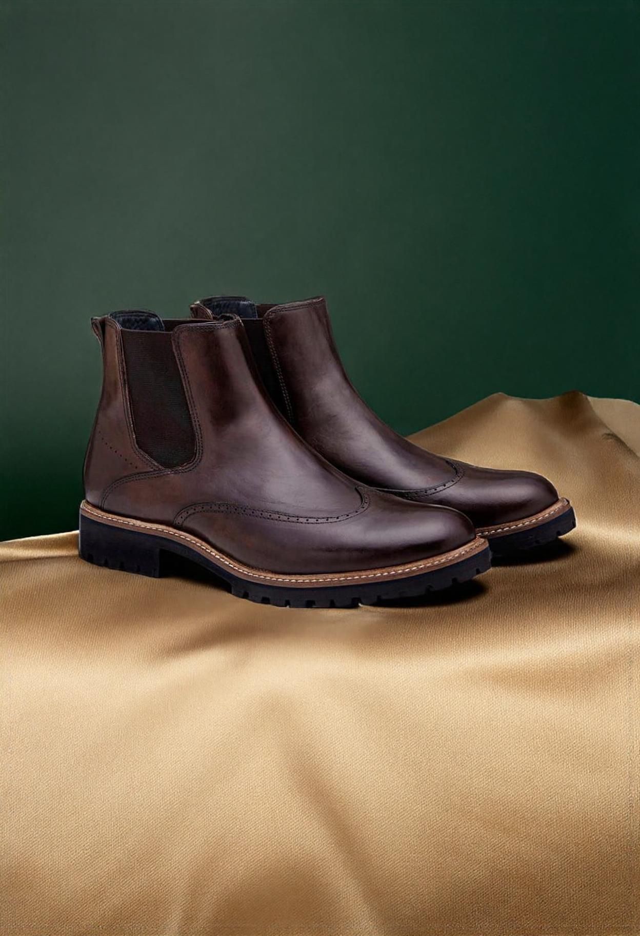 classic dark brown Chelsea boots — elastic side panels, brogue detailing, wingtip toe, lug sole, pull tab