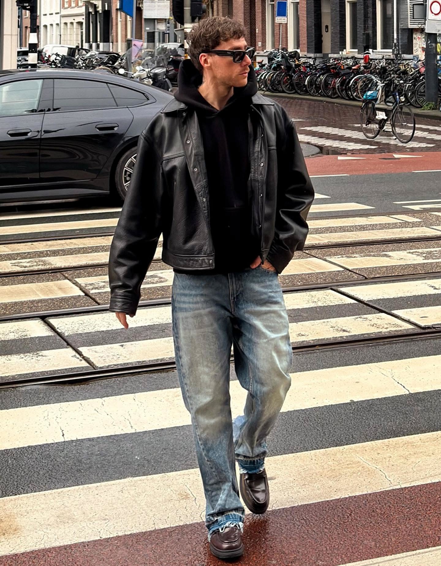 casual black leather jacket — shirt collar, snap button closure, chest pockets, dropped shoulders