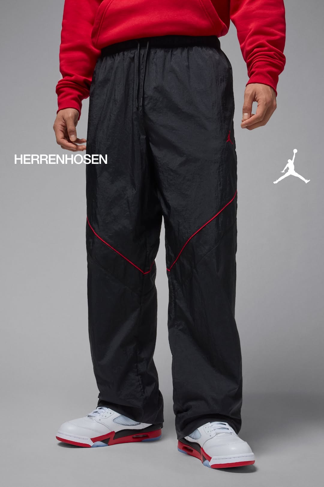 Jordan black with red accents track pants — elastic drawstring waist, red piping details, Jordan Jumpman logo, zippered cuffs