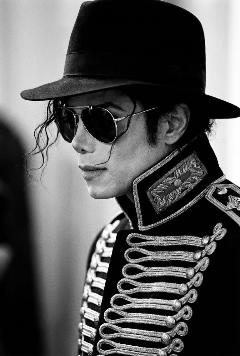 Michael Jackson black with silver accents military jacket — mandarin collar, ornate silver embroidery, silver braided frog closures, shoulder epaulets