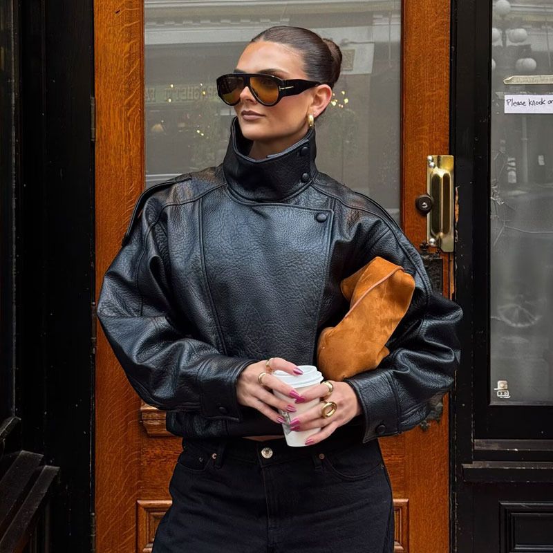 casual black leather bomber jacket — high stand collar, snap button closure, dropped shoulders, ribbed hem, asymmetrical front closure