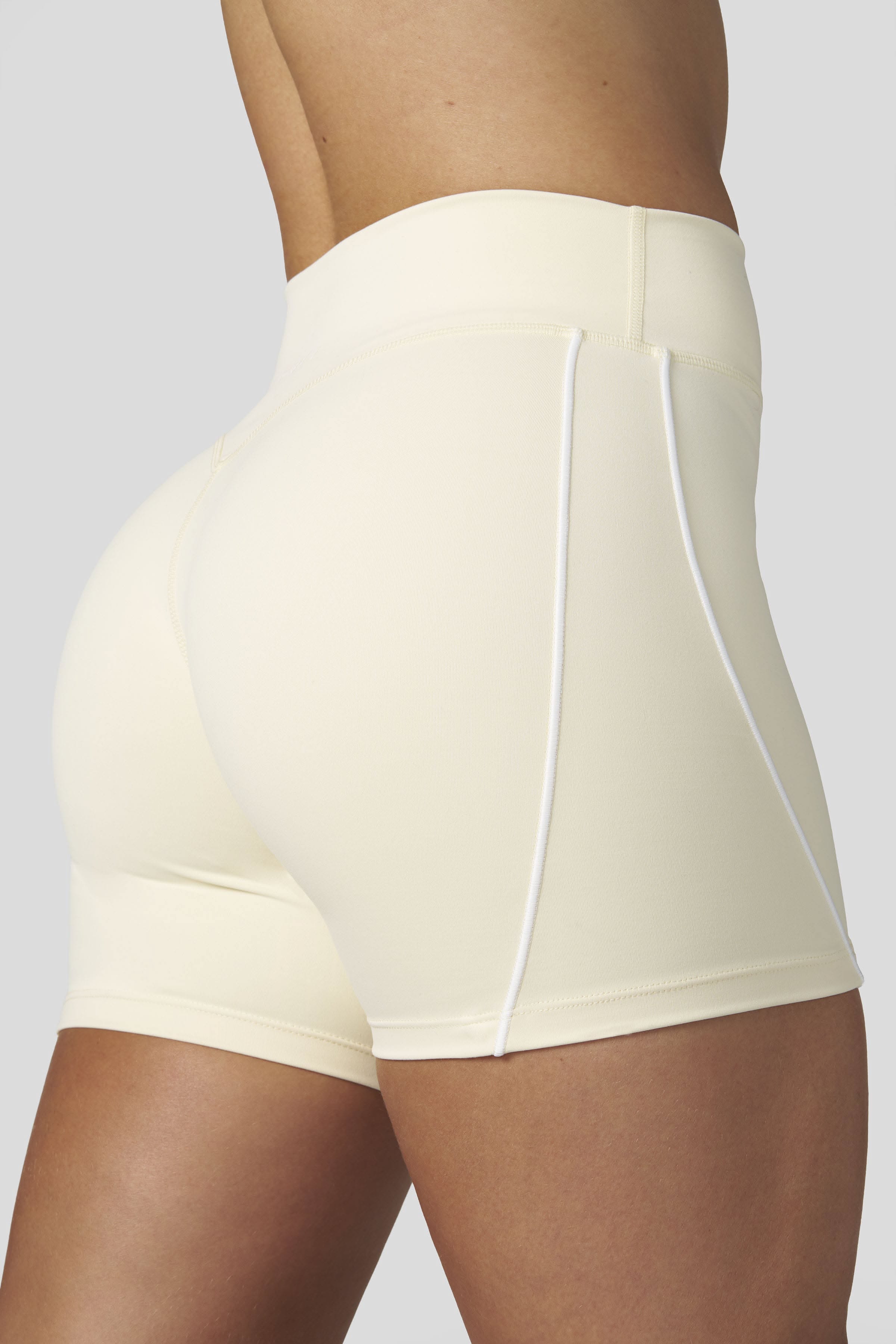 Sporty Cream Athletic Shorts — High-waisted, White Piped Panel Seams