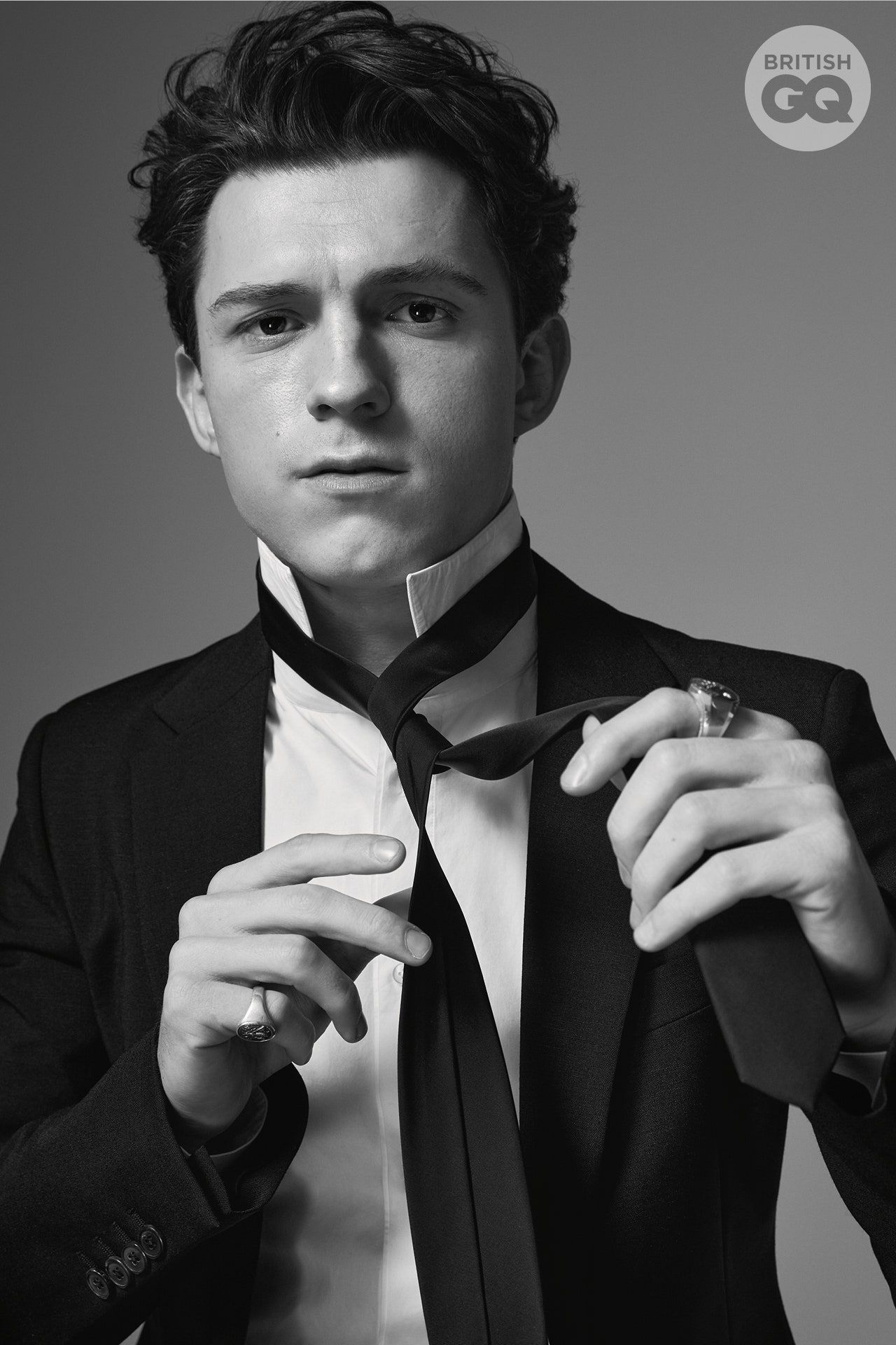 Tom Holland black suit jacket — peak lapel, single-breasted, two-button closure, four-button cuff