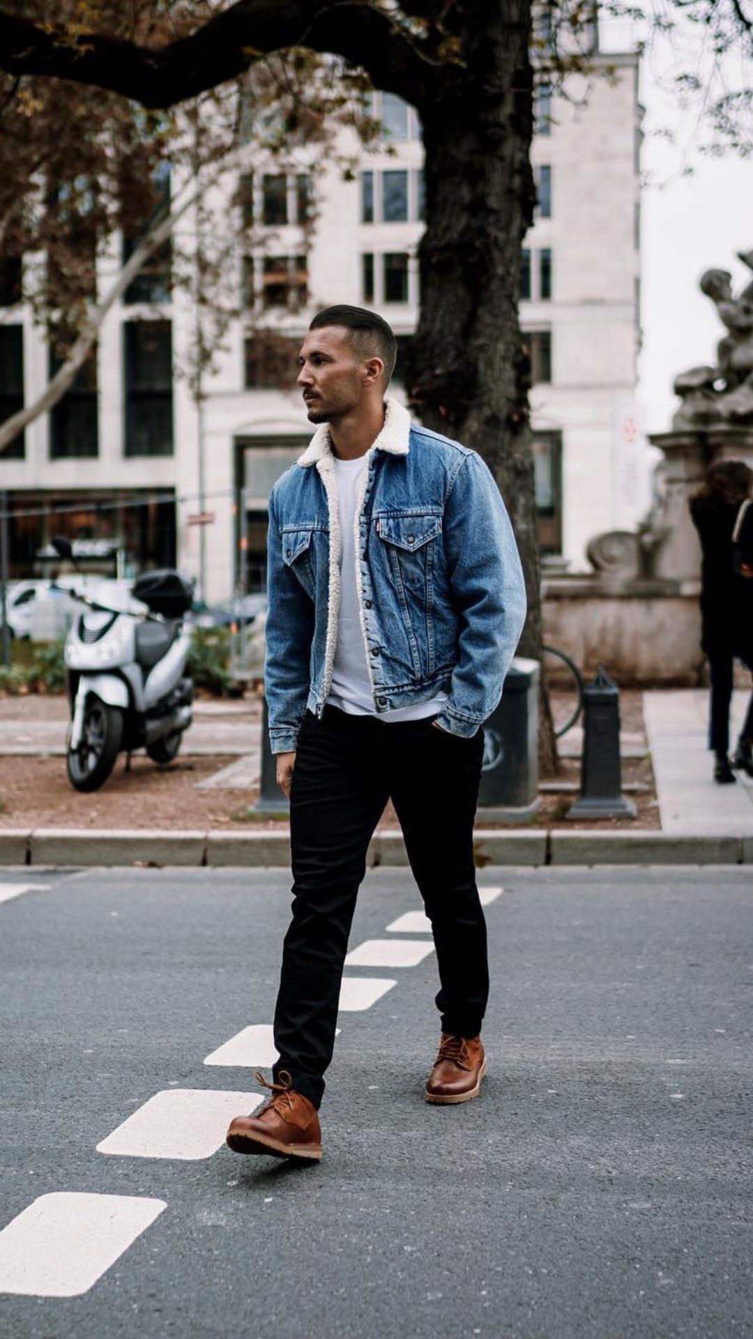 Levi's medium wash blue denim jacket — sherpa collar, sherpa lining, button-front closure, chest flap pockets with button closure, side welt pockets