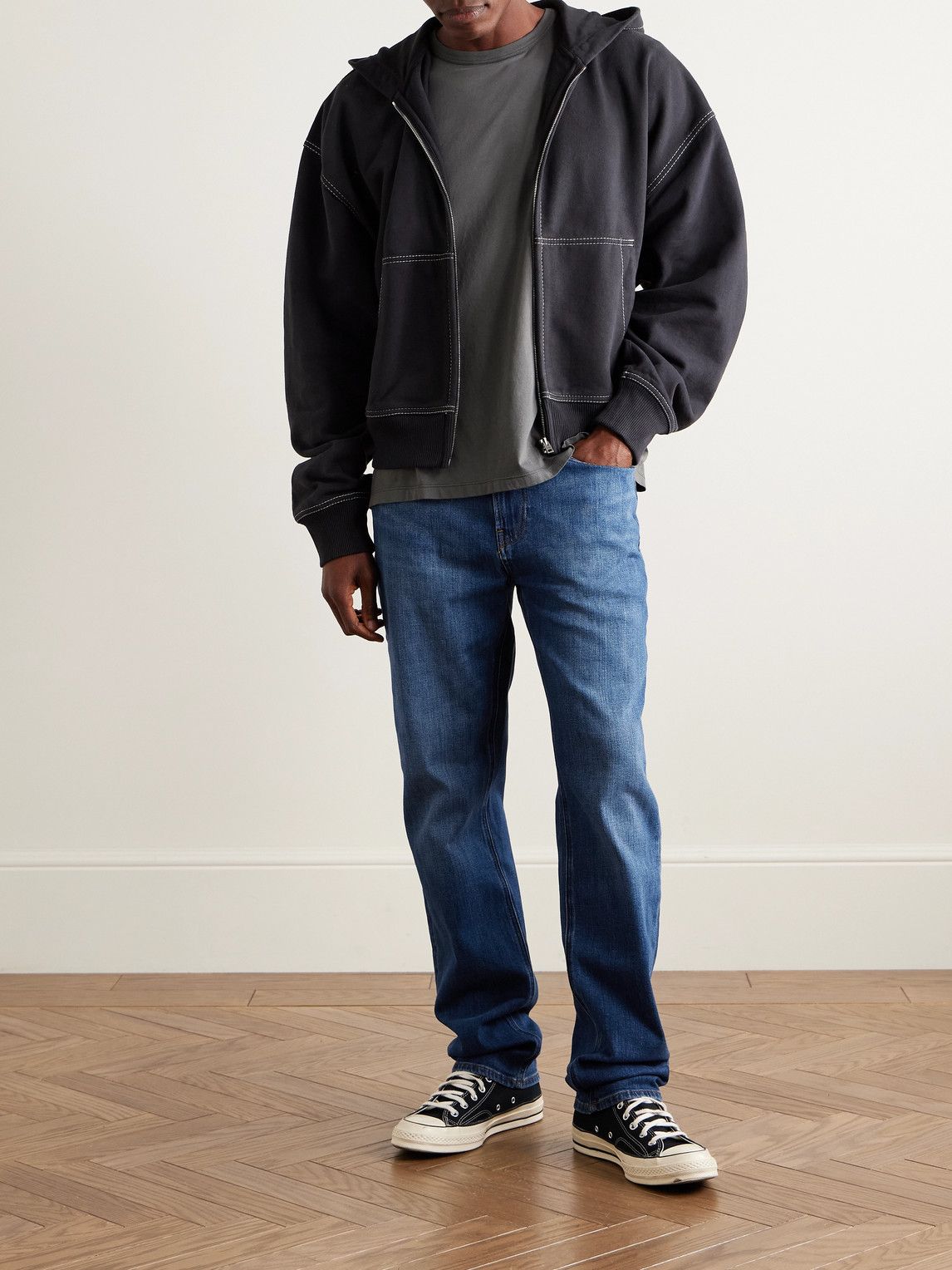 casual medium blue wash jeans — five-pocket style, subtle whiskering, slight fading