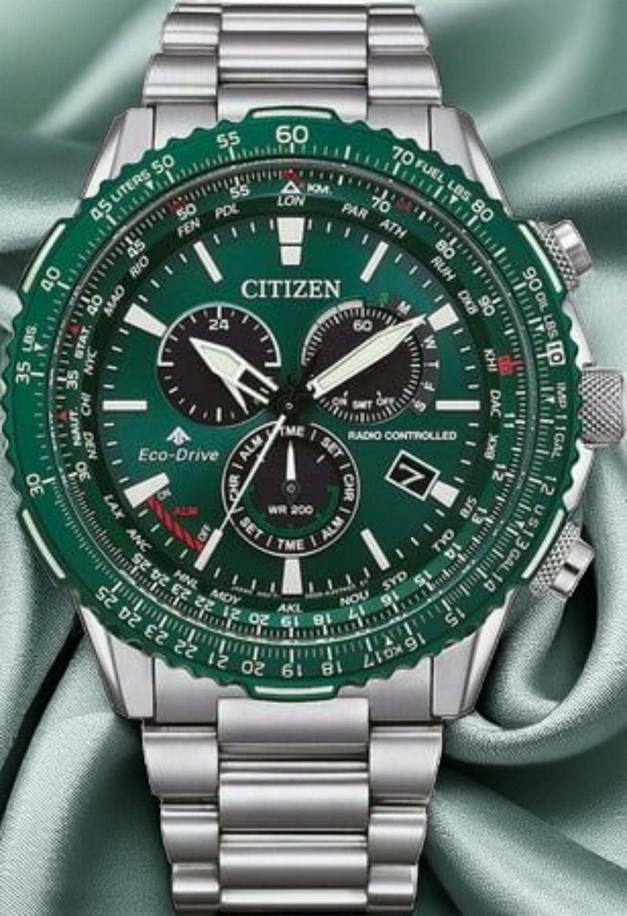 Citizen green dial silver-tone watch — round case, green rotating bezel, green chronograph dial, multiple sub-dials, date window, radio controlled, Eco-Drive, GMT function, three crowns/pushers, link bracelet