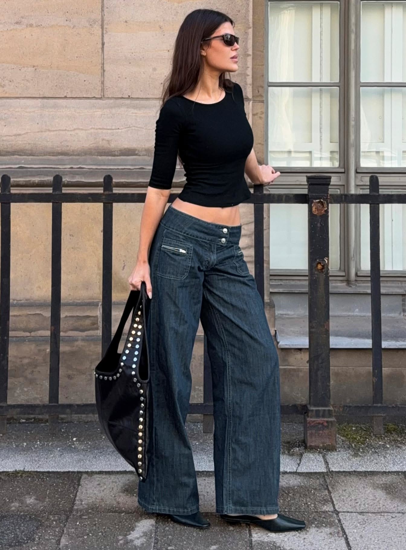 Streetwear dark wash blue jeans — mid-rise waist with double button closure, prominent front zipper pockets, decorative stitching along the front seams, low-slung hip fit