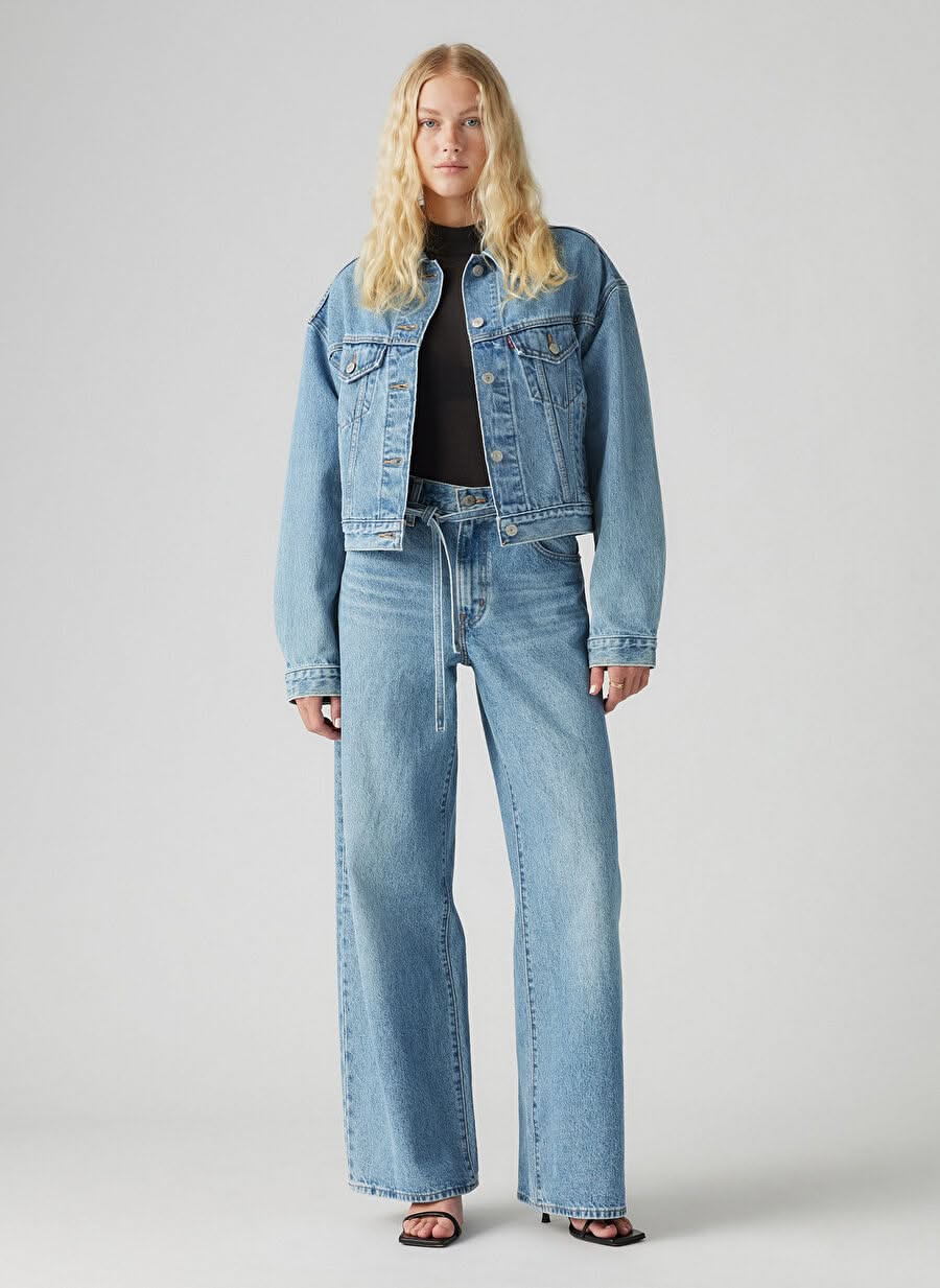 Levi's light wash blue jeans — high-waisted, five-pocket style, tie-waist detail with a white rope-like belt, full length