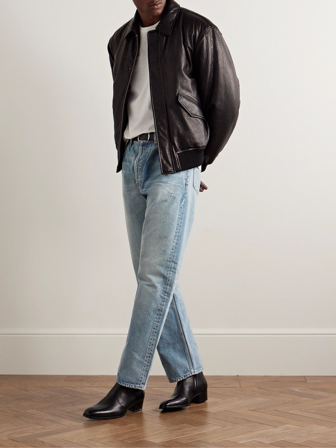 Saint Laurent light wash blue jeans — faded wash, distressed details, five-pocket style