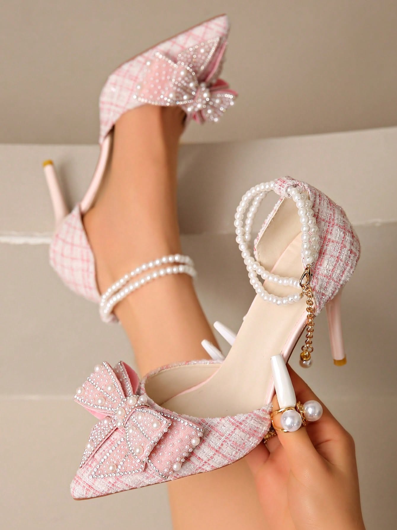 Luxury light pink high heels — pointed toe, stiletto heel, embellished bow with rhinestones and pearls, double pearl ankle strap with dangling pearl charm