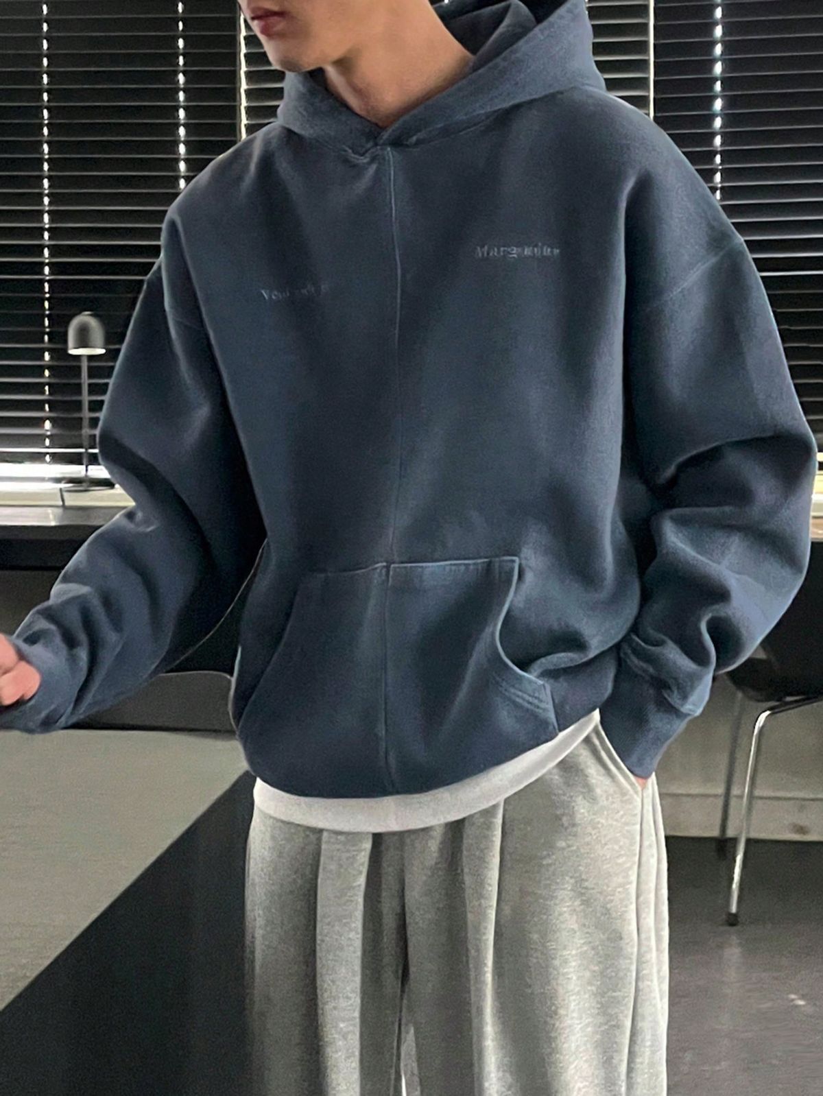 casual faded slate blue hoodie — drawstring hood, kangaroo pocket, dropped shoulders, embroidered text detail