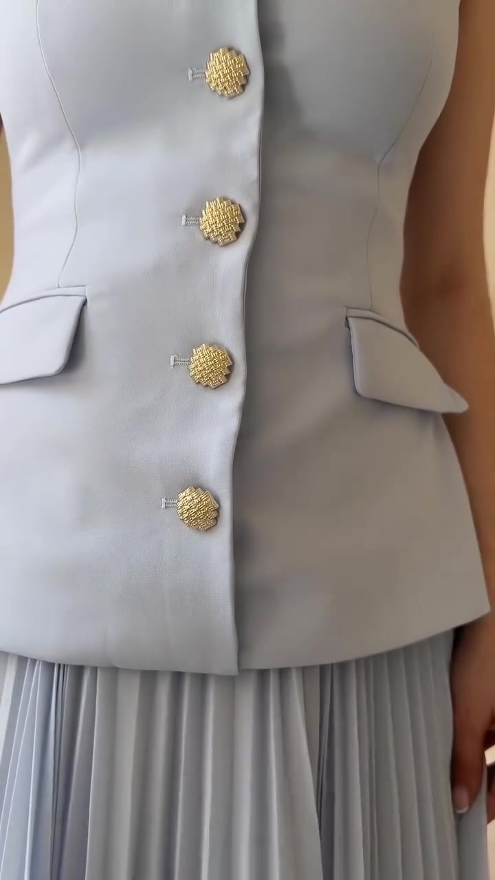 elegant light blue vest and skirt set — sleeveless vest, gold textured buttons, flap pockets on vest, pleated midi skirt