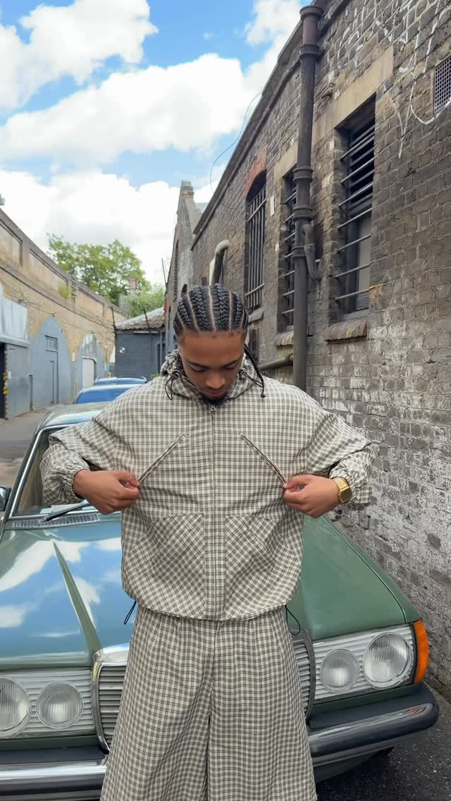 streetwear sage green and off-white tracksuit set — hooded jacket with half-zip, two diagonal chest zippers, front pouch pocket, elasticated cuffs and hem; wide-leg pants with elasticated waist