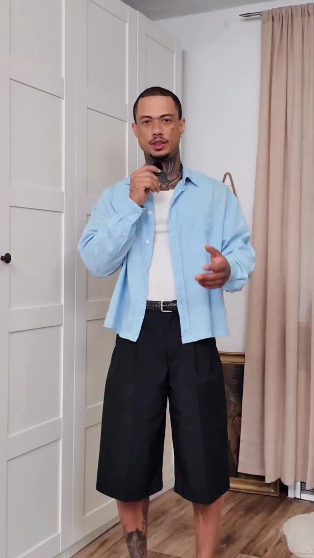 casual light blue button-up shirt — collared, long sleeve, button-front, dropped shoulders