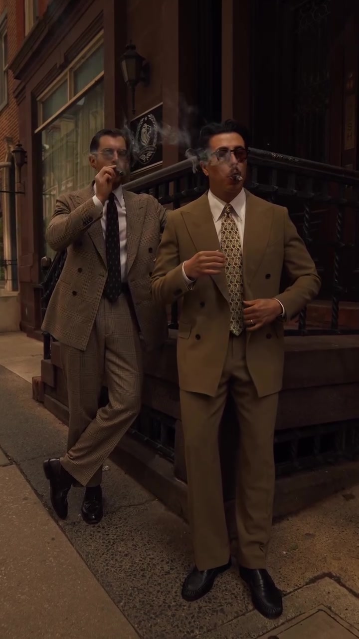 classic camel brown men's suit — double-breasted jacket, wide lapels, two-button closure, flat-front trousers