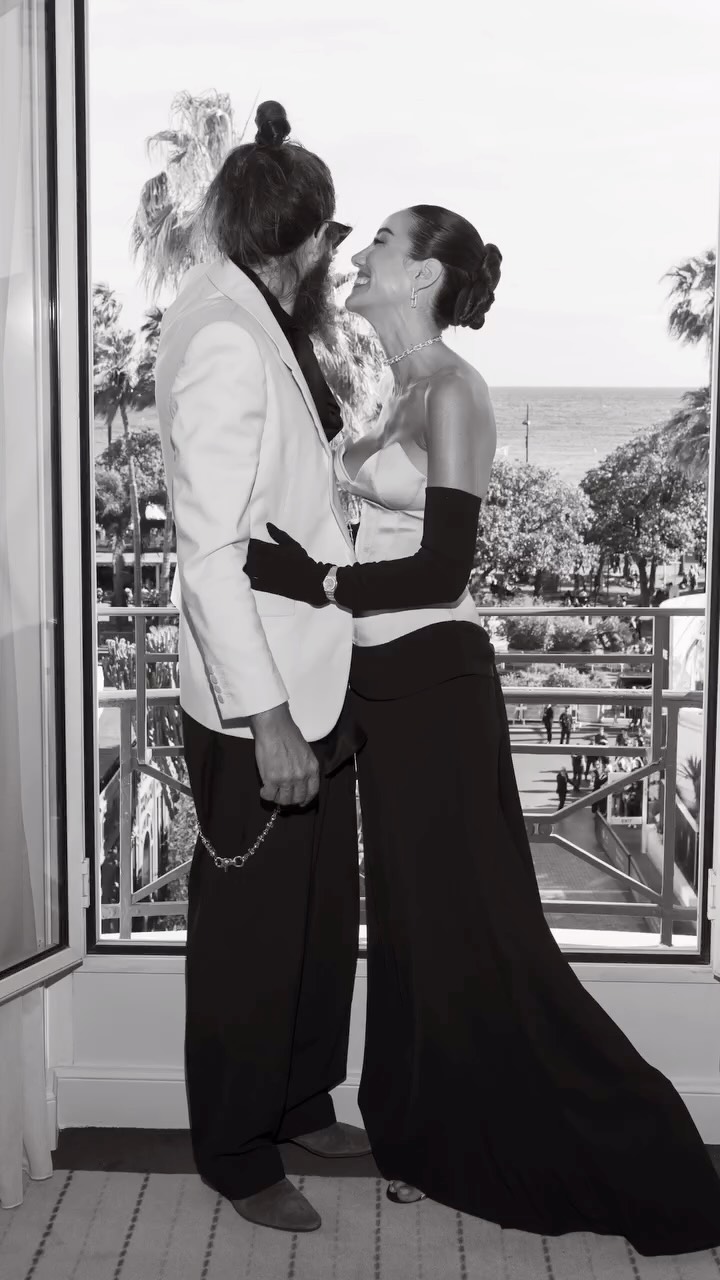 formal black and white trouser set — strapless bustier top, floor-length wide-leg trousers, long opera gloves