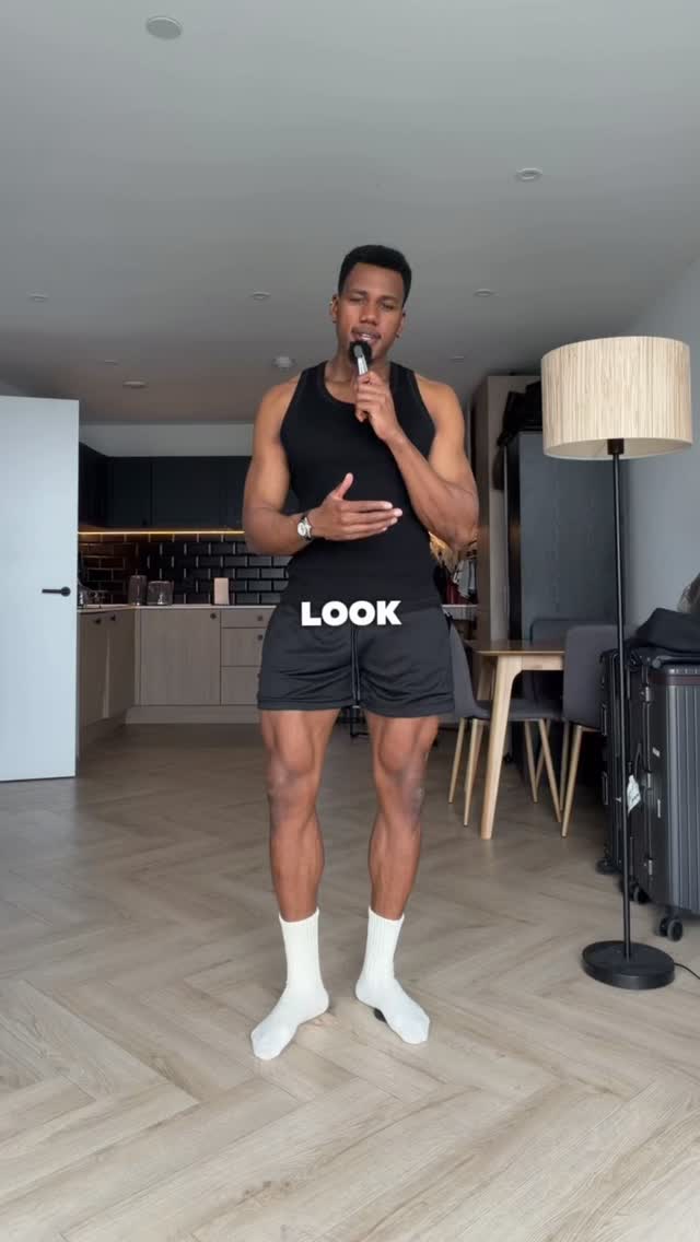 athletic black athletic outfit — crew neck tank top, elastic waist shorts with drawstring, mesh side panels on shorts