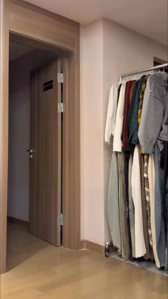 minimalist silver clothing rack — industrial pipe design, rolling casters, single hanging bar