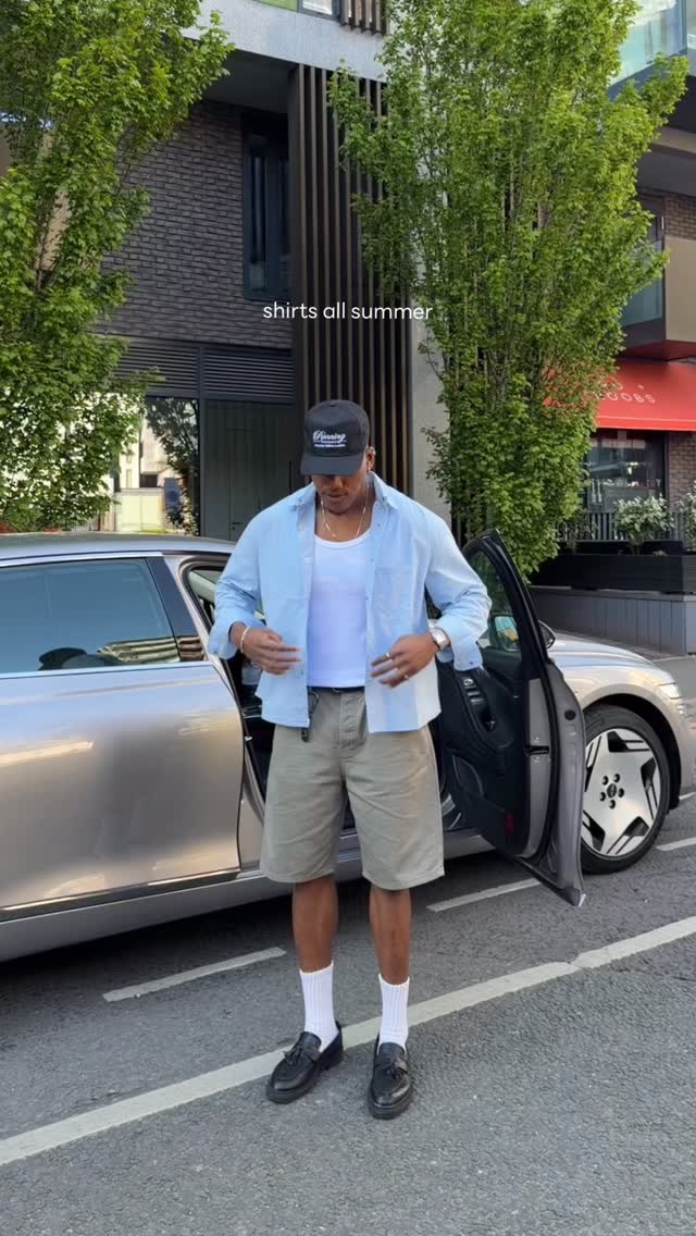 casual light blue button-up shirt — long sleeve, pointed collar, front button closure, chest patch pockets