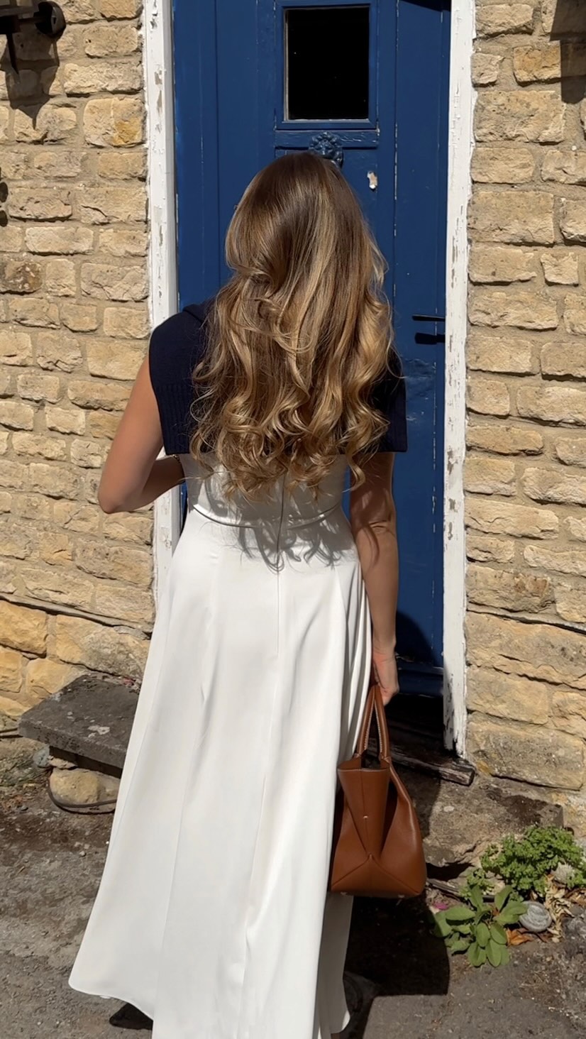 casual white midi dress — sleeveless, square neckline, back zipper, A-line skirt, worn with navy cropped shrug
