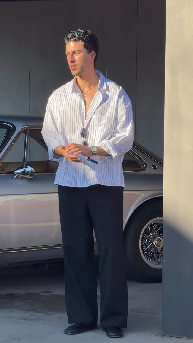 casual white and grey button-down shirt — spread collar, dropped shoulders, long sleeves with rolled cuffs, chest pocket, untucked hem