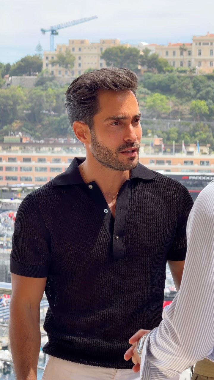 smart casual black polo shirt — short sleeve, spread collar, three-button placket, mother-of-pearl buttons, ribbed texture
