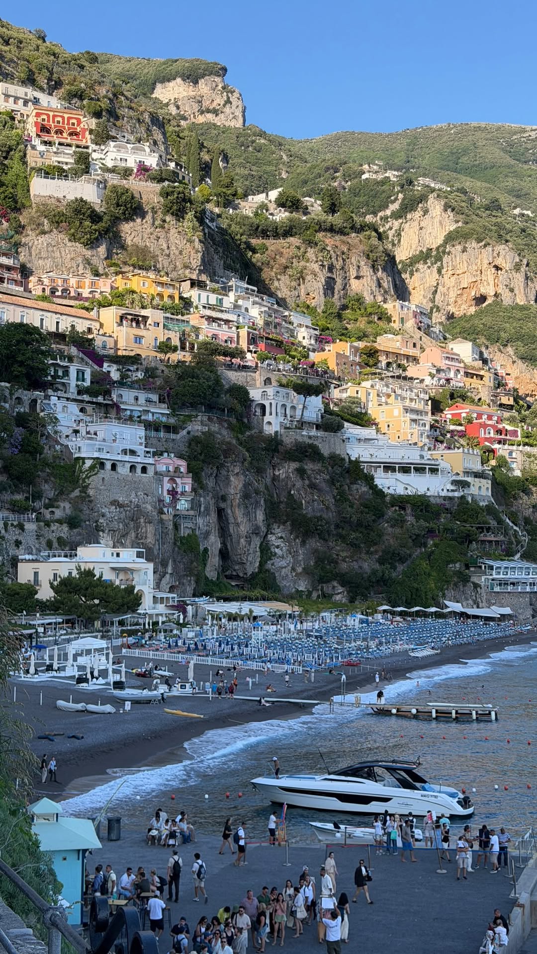 unknown unknown unknown — No specific fashion item is visible or in focus in this image. The image depicts a scenic view of Positano, Italy.