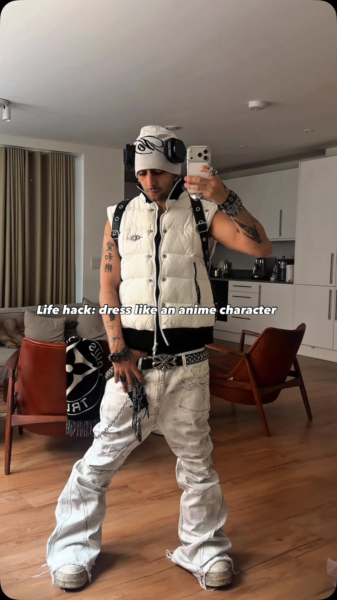streetwear off-white and light wash denim puffer vest and baggy jeans — sleeveless puffer vest, snap button details, black strap accents, low-rise baggy jeans, distressed denim, stacked leg, frayed hem, studded 