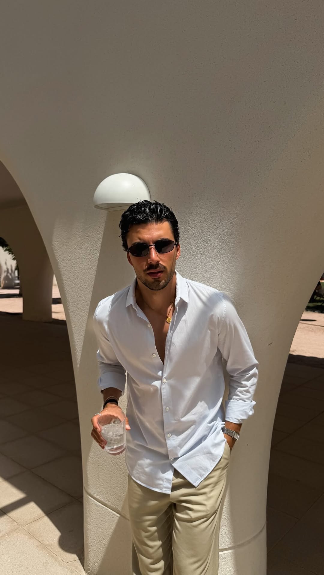 casual light blue button-up shirt — long sleeve, spread collar, button-front, unbuttoned collar, sleeves rolled up