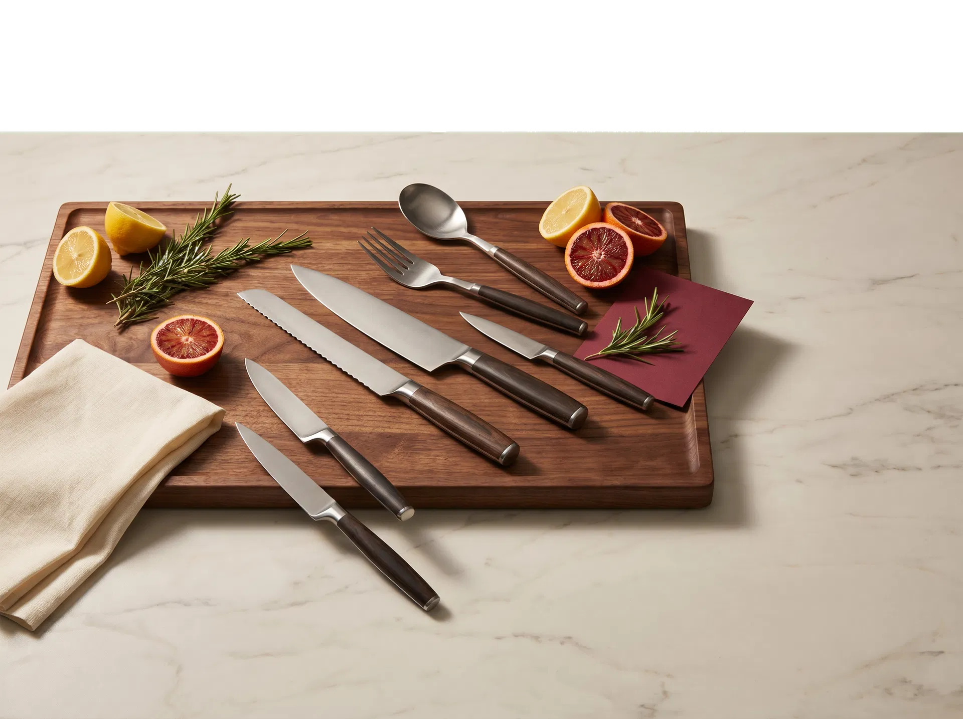 Premium kitchen cutlery displayed on walnut and marble
