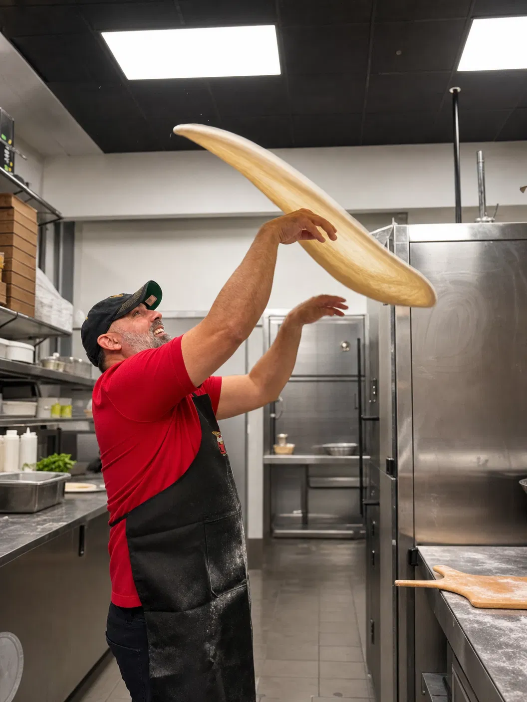 Luno Pizza chef tossing dough in the kitchen