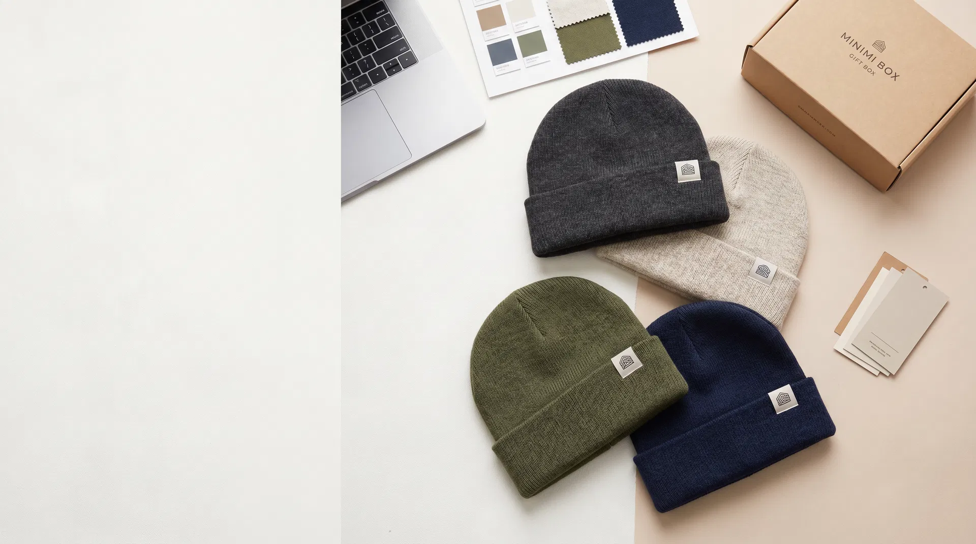 Premium flat lay of custom logo beanies, packaging and brand launch materials for DTC brands