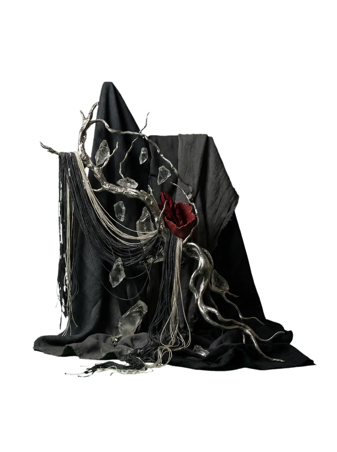 Symbolic sculptural still-life suggesting the artist presence through cloth, metal, crystal, and thread