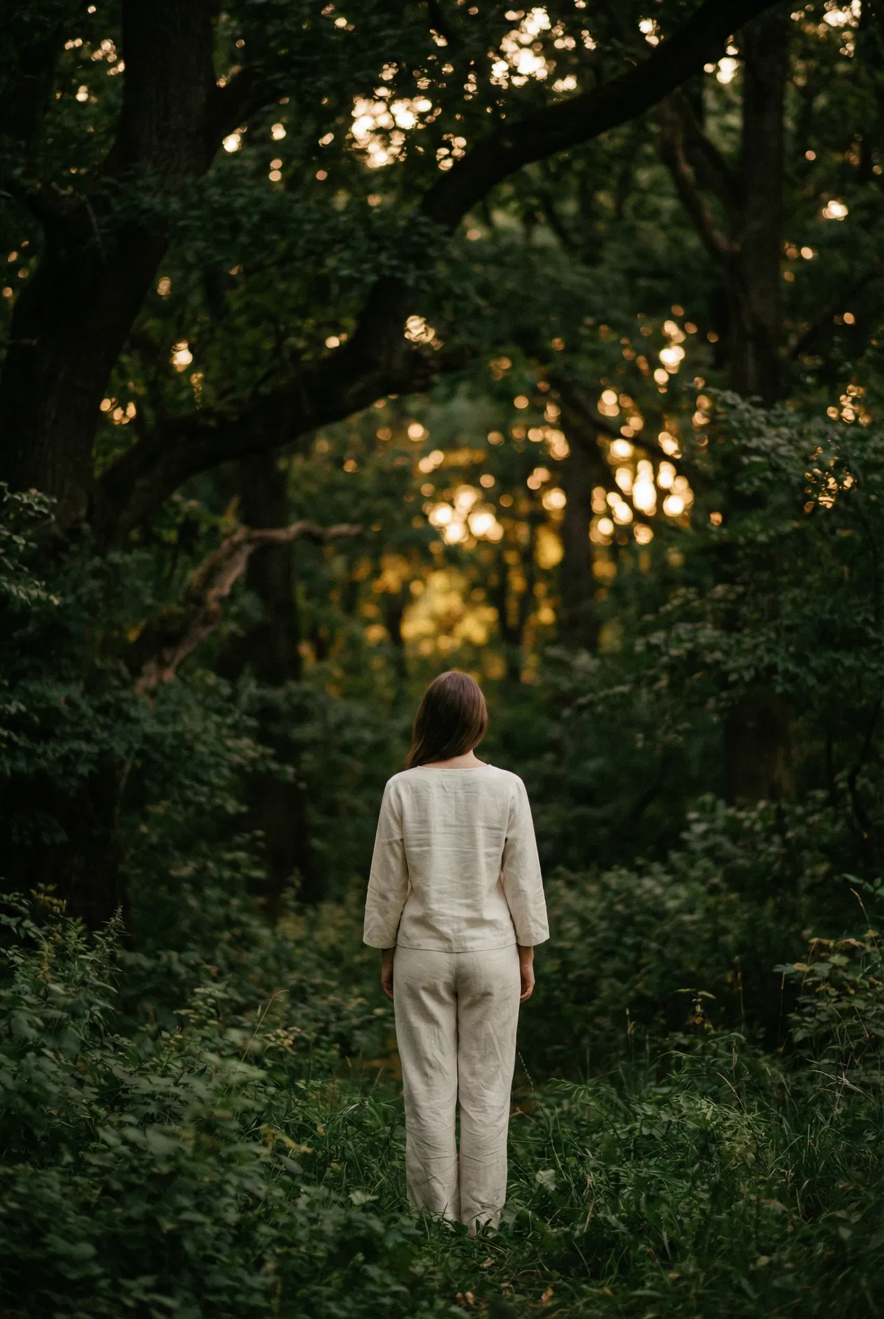 Woman in forest at golden hour