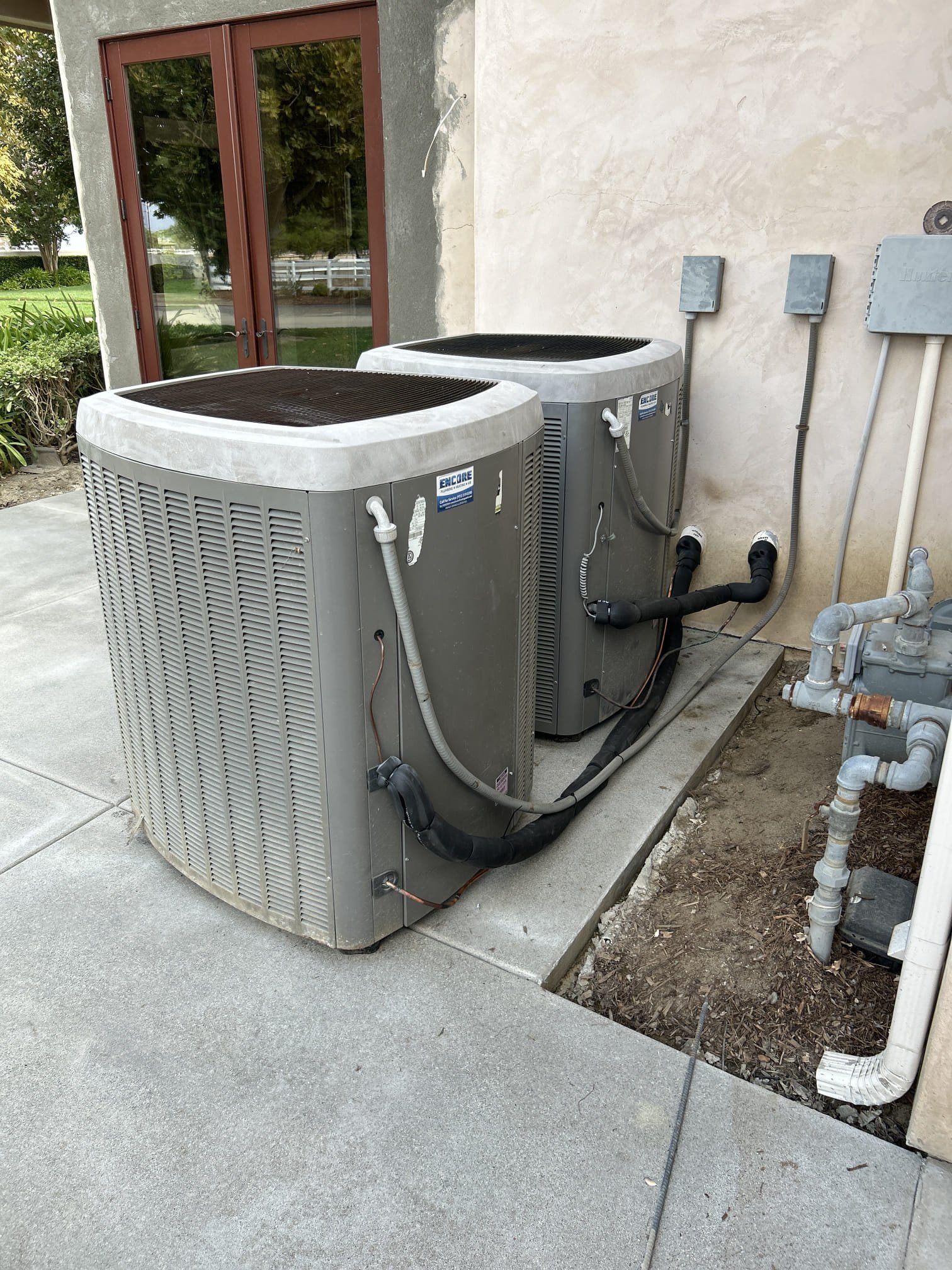 Outdoor air conditioning units after professional removal and reinstallation for an On Time Home Services customer in Temecula, California.