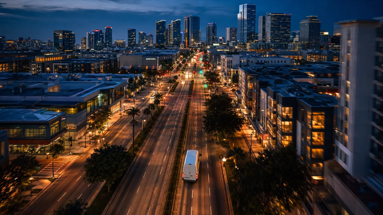 Delivery van driving through city at dusk