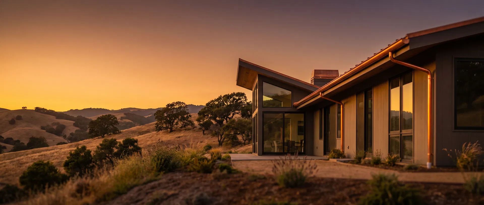 Modern California home with professionally installed seamless copper rain gutters at golden hour, Ventura County